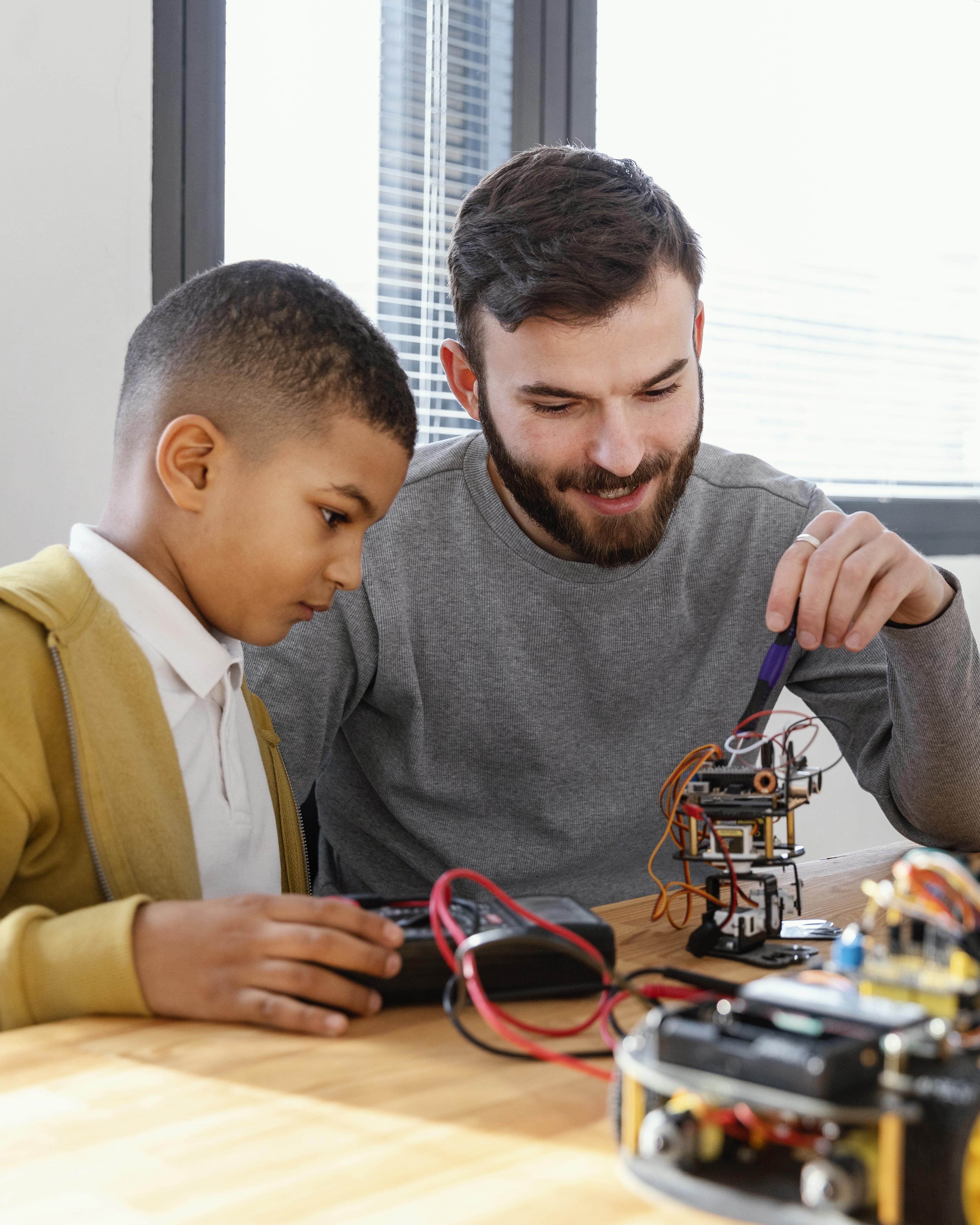 Instructor interacting with robotics learning setup
